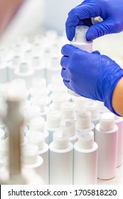 Empty Bottles On A Cosmetic Manufacturing Assembly Line