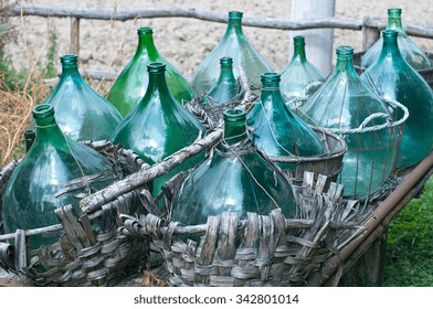 Empty bottles of wine on old wagon, italy