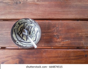 Empty Bowl After Eating Ice Cream On A Wooden Table.