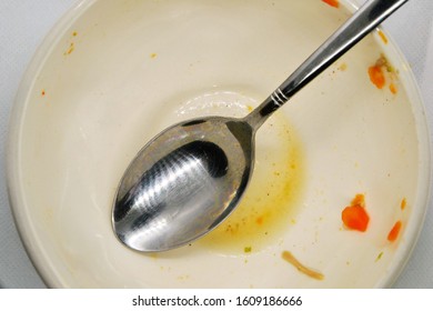 Empty Bowl. Dirty, Empty Bowl With Spoon. After Meal. Top View. Dirty Bowl With Food Leftovers