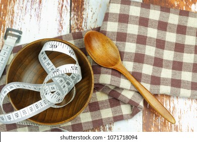 Empty Bowl, Spoon And Measurement Tape On The Table. Concept Of Weight Management,weight Issue,lifestyle Changes, Weight Loss Health Issue And Social Issue