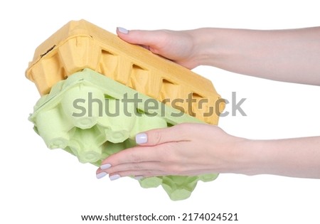 Empty box for eggs in hand on white background isolation