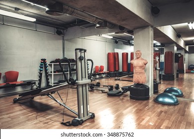 Empty Boxing Area In The Gym. Fitness Club With Equipment. Sports Background With Rough Concrete Walls