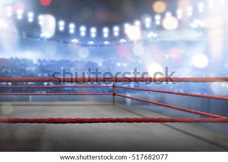 Empty boxing ring with red ropes for match in the stadium arena