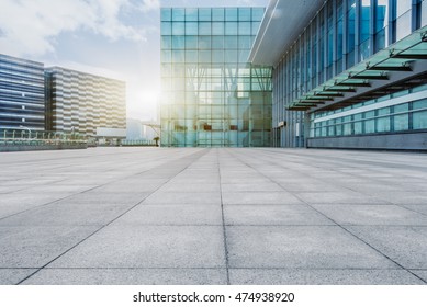 empty brick floor with modern building in background - Shutterstock ID 474938920