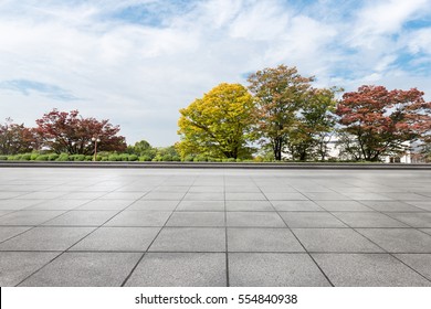 Empty Brick Floor Near Park In Cloud Sky