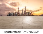 empty brick platform with Shanghai skyline in background at twilight.