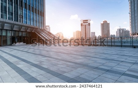 Empty brick road in front of office buildings