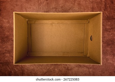 Empty Brown Cardboard Box On Grunge Background, Overhead Shot Top View.