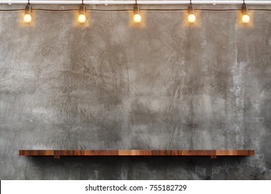 Empty Brown Wood Plank Board Shelf At Grunge Concrete Wall With Light Bulb String Party Background,Mock Up For Display Or Montage Of Product Or Design.