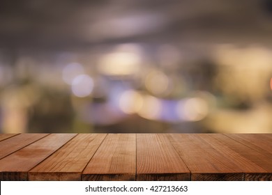  Empty brown wooden table and blur background of abstract blurred background of resturant lights ,for product display montage,can be used for montage or display your products  - Shutterstock ID 427213663