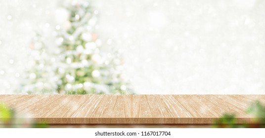 Empty Brown Wooden Table Top With Abstract Muted Blur Christmas Tree And Snow Fall Background With Bokeh Light,Holiday Backdrop,Mock Up Banner For Display Or Montage Of Product