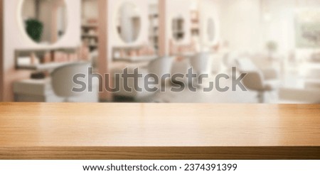 empty brown wooden tabletop for product display on blurred beauty and hair salon interior background