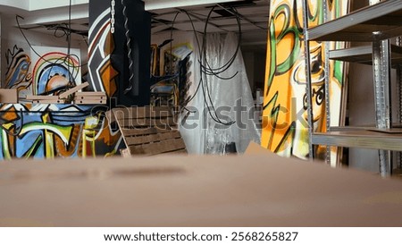 Empty building with destroyed items and graffiti paint, concept of subversive lifestyle. Criminal hideout used by teenagers to hangout and commit illegal drawing on walls