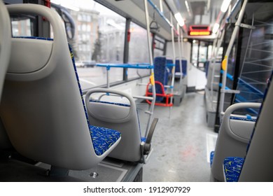 Empty bus interior. Blue seats without passengers. Public transport. Transportation of passengers by public transport. Ergonomic interior of the bus. Travel to other cities.