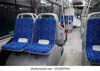 Empty bus interior. Blue seats without passengers. Public transport. Transportation of passengers by public transport. Ergonomic interior of the bus. Travel to other cities.