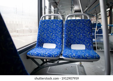 Empty bus interior. Blue seats without passengers. Public transport. Transportation of passengers by public transport. Ergonomic interior of the bus. Travel to other cities.