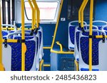 Empty bus interior. Seats without passengers. Public transport. Transportation of passengers by public transport. Ergonomic interior of the bus. Travel to other cities.