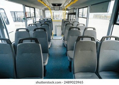 Empty bus interior. Seats without passengers. Public transport. Transportation of passengers by public transport. Ergonomic interior of the bus. Travel to other cities. - Powered by Shutterstock