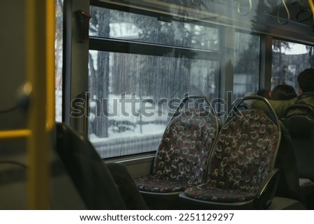 Empty bus seat. Public transport, 
two empty seats. People sitting backwards. Selective focus. Vintage effect, contains grain. Underexposure photo.