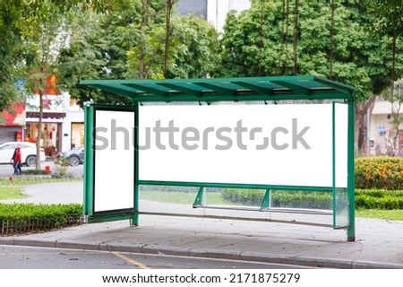 An empty bus stop with blank advertising board