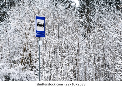 Empty bus stop on a winter road. Traffic and vehicles in a winter season.