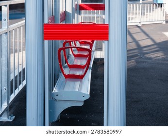 Empty bus stop with red seating area medium shot selective focus