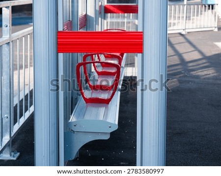 Empty bus stop with red seating area medium shot selective focus
