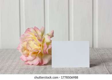 Empty Business Card And A Rose Flower On The Table. Mockup, Scene Creator.