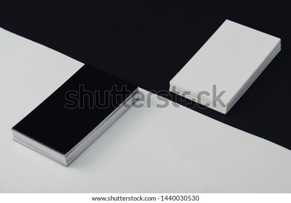empty business cards stacked on black and\
white background