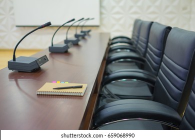 Empty business conference table and chairs in meeting room