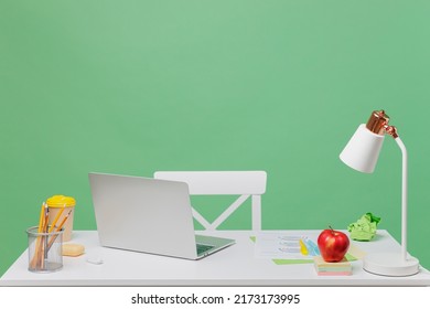 Empty business workplace room with white desk, laptop pc computer gadget stationery isolated on plain pastel green color background studio. Contemporary design of comfortable cozy office concept - Shutterstock ID 2173173995