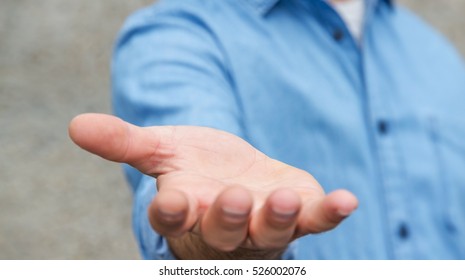 Empty businessman hand on bright blurred background