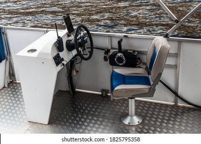 Empty cabin of a pleasure boat. Empty chair in front of the dashboard