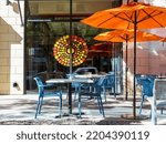 Empty cafe with tables and chairs. Street exterior of a restaurant in Cherry Creek district, Denver, Colorado