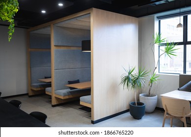 Empty Cafeteria In Creative Office With Booths, Table, Window And Plants. Modern Creative Office Space.