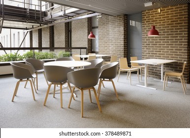 An empty cafeteria interior shot. Large windows letting in light. - Shutterstock ID 378489871