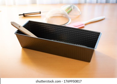 Empty Cake Tin With Baking Utensils On A Table