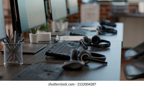 Empty Call Center Office With Computers And Audio Headsets Used To Have Conversation With People On Customer Service Helpline. Nobody At Telemarketing Workstation With Technology.