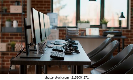 Empty call center workstation with headsets and computers, used by people working at customer care service. Nobody in office with headphones, microphones and monitors for helpline support. - Shutterstock ID 2152004271