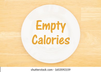 Empty Calories Message On White Empty Plate On A Wood Table