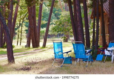 Empty Camping Chairs In The Pine Tree Forest At The Evening Time. Place For Weekend Escape And Relax During Summertime. Soria, Spain