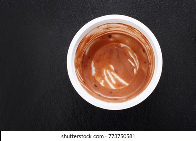 Empty Can Of Chocolate Ice Cream On A Black