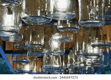 a lot of empty cans with a lighting lamp on the ceiling in the store, a close-up photo                      