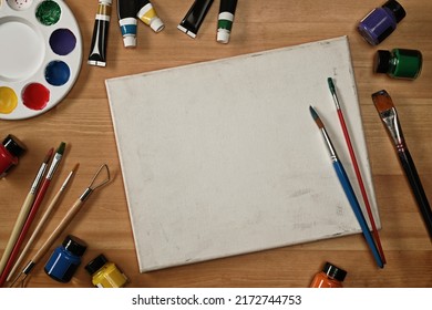 Empty canvas paint brushes, tube paint, watercolor and palette on wooden table. Art, workshop, painting, creativity concept - Powered by Shutterstock