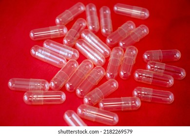 Empty Capsule Pill On A Bright Red Background