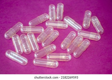 Empty Capsule Pill On A Bright Pink Background