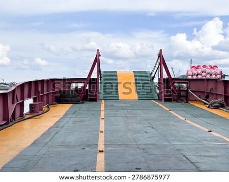 Empty Car Ferry Deck with Raised Loading Ramp Under Blue Sky 