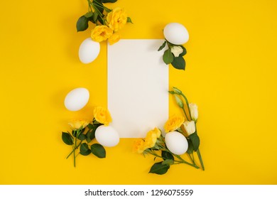 Empty card with easter decorations on yellow background with copy space