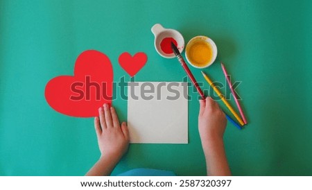 Empty card. Flat lay. Children's hand Greeting Mom Kid Paint handmade Heart Card. Emerald Back. Mother's Day, birthday, love, care, Loving son, pencils, brush, paint, art item